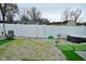 Fenced backyard with gravel, artificial turf, hot tub, and outdoor seating at 7527 Derek Dr, Camby, IN 46113