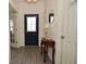 Inviting entryway with stylish floors, decorative table, and laundry room access at 7527 Derek Dr, Camby, IN 46113