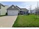 Charming home featuring a well-manicured lawn and a convenient two-car garage at 7527 Derek Dr, Camby, IN 46113