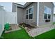 Close up of a backyard with a small garden and artificial turf at 7527 Derek Dr, Camby, IN 46113