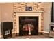 Stone fireplace with a clean white mantel offering decorative display space in the living room at 7527 Derek Dr, Camby, IN 46113