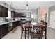 Beautiful kitchen with stainless appliances, dark wood cabinets and a view of entryway at 7527 Derek Dr, Camby, IN 46113