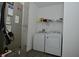 The laundry room features modern appliances and shelving at 7527 Derek Dr, Camby, IN 46113