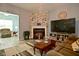 Spacious living room with a fireplace, comfortable seating, and an entertainment center with a large television at 7527 Derek Dr, Camby, IN 46113