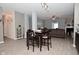 Open floor plan view showcasing dining area leading into the living room with a fireplace and neutral tones at 7527 Derek Dr, Camby, IN 46113
