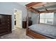Spacious main bedroom with a four-poster bed, gray walls, and an open doorway to the en suite bathroom at 7527 Derek Dr, Camby, IN 46113