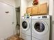 Convenient laundry room with modern washer and dryer units, storage cabinets, and ample space at 768 Pine Lake Dr, Greenwood, IN 46143