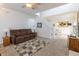 Bright living room featuring a cozy sofa, stairway and an open dining area at 768 Pine Lake Dr, Greenwood, IN 46143
