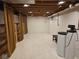 Spacious basement with exposed ceilings, curtain and shelving at 7809 Bryden Dr, Fishers, IN 46038
