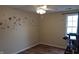 Bright bedroom with wood floor, a ceiling fan, sea-themed decals, and natural light from a window at 7809 Bryden Dr, Fishers, IN 46038