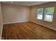Bright bedroom features hardwood floors, two large windows, and closet at 7809 Bryden Dr, Fishers, IN 46038