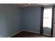 A blue-painted bedroom with a window with dark curtains and hardwood floors at 7809 Bryden Dr, Fishers, IN 46038
