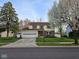 Charming two-story home with a well-manicured lawn and attached garage with a concrete driveway at 7809 Bryden Dr, Fishers, IN 46038