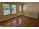 Cozy living room with hardwood floors and natural light from two large windows at 7809 Bryden Dr, Fishers, IN 46038