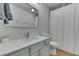 Bathroom featuring a white marble counter, modern sink faucet, and white tiled shower with curtain at 855 Queensgate Dr, Greenwood, IN 46143