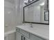 A clean bathroom featuring a large mirror, white countertops, and a shower with white tile at 855 Queensgate Dr, Greenwood, IN 46143