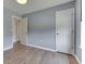 A spare bedroom with grey paint, and two closets at 855 Queensgate Dr, Greenwood, IN 46143