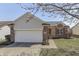 Charming single-story home with a brick and gray siding exterior and attached two-car garage at 855 Queensgate Dr, Greenwood, IN 46143