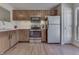 Cozy kitchen featuring wood cabinets, stainless steel appliances, and a white subway tile backsplash at 855 Queensgate Dr, Greenwood, IN 46143