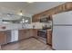 Well-lit kitchen features wood cabinets, stainless steel appliances, and bright countertops at 855 Queensgate Dr, Greenwood, IN 46143