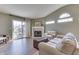 Inviting living room featuring a fireplace, vaulted ceilings, and access to the patio at 855 Queensgate Dr, Greenwood, IN 46143