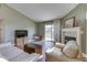 Cozy living room featuring a fireplace, comfortable seating, and a sliding glass door to the backyard at 855 Queensgate Dr, Greenwood, IN 46143