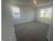Bright bedroom with carpet floors and two windows allowing plenty of natural light at 8727 Duncan St, Fortville, IN 46040