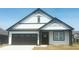 Beautiful one-story home with a black-and-white color scheme and a two-car garage at 8727 Duncan St, Fortville, IN 46040