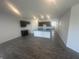 Open-concept kitchen with dark cabinetry, a light blue countertop, and hardwood floors at 8727 Duncan St, Fortville, IN 46040