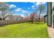Expansive backyard with a privacy fence and mature trees, perfect for outdoor activities at 8807 Wintergreen Way, Indianapolis, IN 46256