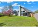 Spacious backyard featuring a well-maintained lawn, wooden fence, and a patio area at 8807 Wintergreen Way, Indianapolis, IN 46256