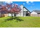 Green backyard with a wooden fence and a mature tree, providing a serene outdoor space at 8807 Wintergreen Way, Indianapolis, IN 46256