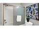 Well-lit bathroom with shower, decorative art, and toilet at 8807 Wintergreen Way, Indianapolis, IN 46256