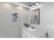 Bathroom featuring white vanity with stone countertops, framed mirror and modern lighting at 8807 Wintergreen Way, Indianapolis, IN 46256