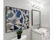 Modern bathroom with stylish lighting, framed mirror, and decorative art at 8807 Wintergreen Way, Indianapolis, IN 46256