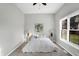Well lit bedroom with neutral walls, a ceiling fan, carpet and window providing natural light at 8807 Wintergreen Way, Indianapolis, IN 46256