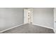 Neutral bedroom with gray carpet and trim with open white door to the rest of the house at 8807 Wintergreen Way, Indianapolis, IN 46256