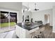 Open-concept kitchen featuring a large island with seating and stainless steel appliances at 8807 Wintergreen Way, Indianapolis, IN 46256