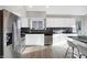 Updated kitchen boasts white cabinets, stainless steel appliances, and modern backsplash at 8807 Wintergreen Way, Indianapolis, IN 46256