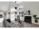 Bright living room with vaulted ceilings, black tile fireplace, and an open view of the kitchen at 8807 Wintergreen Way, Indianapolis, IN 46256