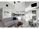 Open-concept living room flowing seamlessly into the kitchen, featuring vaulted ceilings and large windows at 8807 Wintergreen Way, Indianapolis, IN 46256