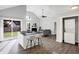 Open-concept interior showcasing the kitchen island, living room, and stacked washer and dryer at 8807 Wintergreen Way, Indianapolis, IN 46256