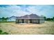 The backyard features gray siding, sliding glass doors, and a concrete patio at 9182 Mulligan Ct, Elwood, IN 46036