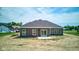 The backyard features gray siding, sliding glass doors, and a concrete patio at 9182 Mulligan Ct, Elwood, IN 46036