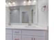 Bright bathroom with double sinks, vanity, and a view into the marble-tiled shower at 9182 Mulligan Ct, Elwood, IN 46036
