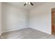 Neutral bedroom featuring a ceiling fan, door, and neutral carpeting at 9182 Mulligan Ct, Elwood, IN 46036
