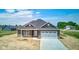Charming single-Gathering home features gray siding, a concrete driveway, and a two-car garage at 9182 Mulligan Ct, Elwood, IN 46036