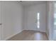 Bright foyer featuring light wood floors and a white front door with glass panes at 9182 Mulligan Ct, Elwood, IN 46036