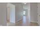 Hallway with light wood floors and white walls leads to other rooms in the home at 9182 Mulligan Ct, Elwood, IN 46036