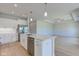 Open kitchen with an island, stainless steel appliances, and seamless flow into the living area at 9182 Mulligan Ct, Elwood, IN 46036